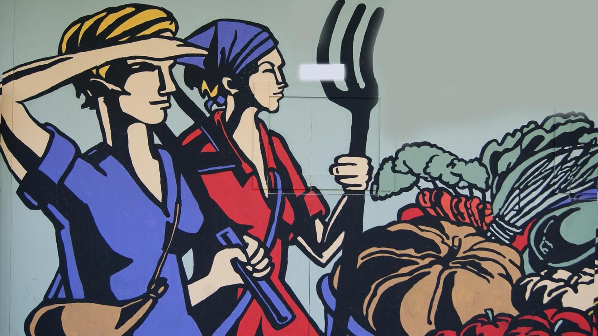 Een muurschildering van twee vrouwen in overalls. Ze kijken in de verte.